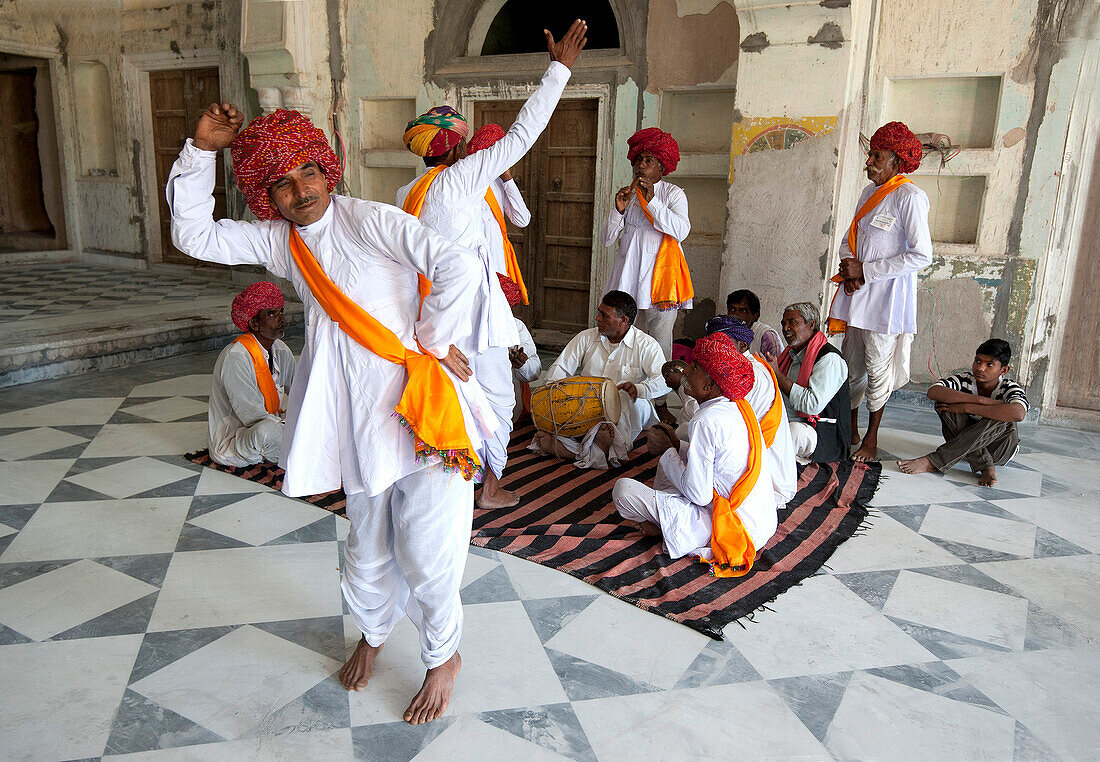 Troup of Rajasthani dancers and musicians performing traditional dance in 18th century Diggi palace Durbar Hall, Rajasthan, India, Asia
