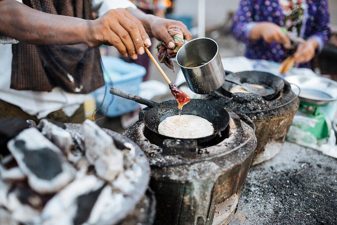 Man making pancakes at street stall, Yangon (Rangoon), Myanmar (Burma), Asia