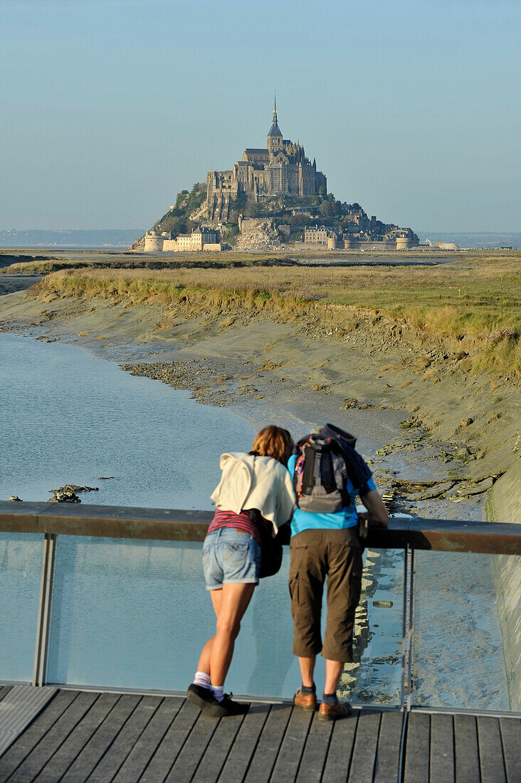 France, Lower Normandy Region, Manche Department, Mont St-Michel seen from the dam on Couesnon river, couple of visitors.