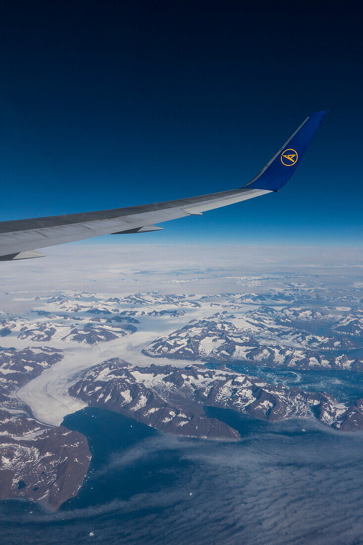 Aerial of wing and winglet of Condor B-767-300ER (D-ABUB) during flight DE 2062 from Frankfurt to Las Vegas with mountains and glacier on eastern coast of Greenland, above Greenland