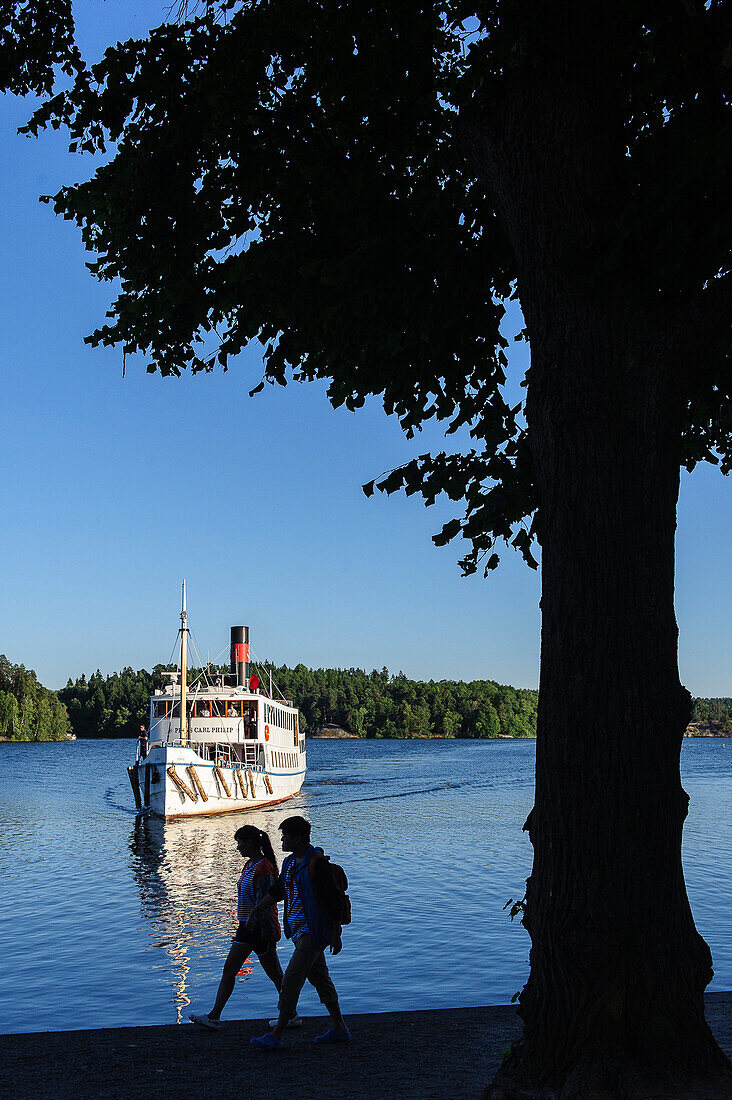 Excursion boat drives to the castle Drottningholm, Stockholm, Sweden