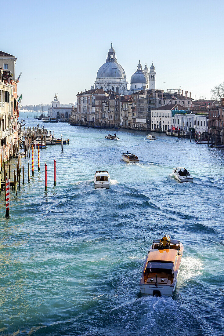 view of the grand canal, motoscafo taxi boat and the santa maria della salute basilica, venice, italy