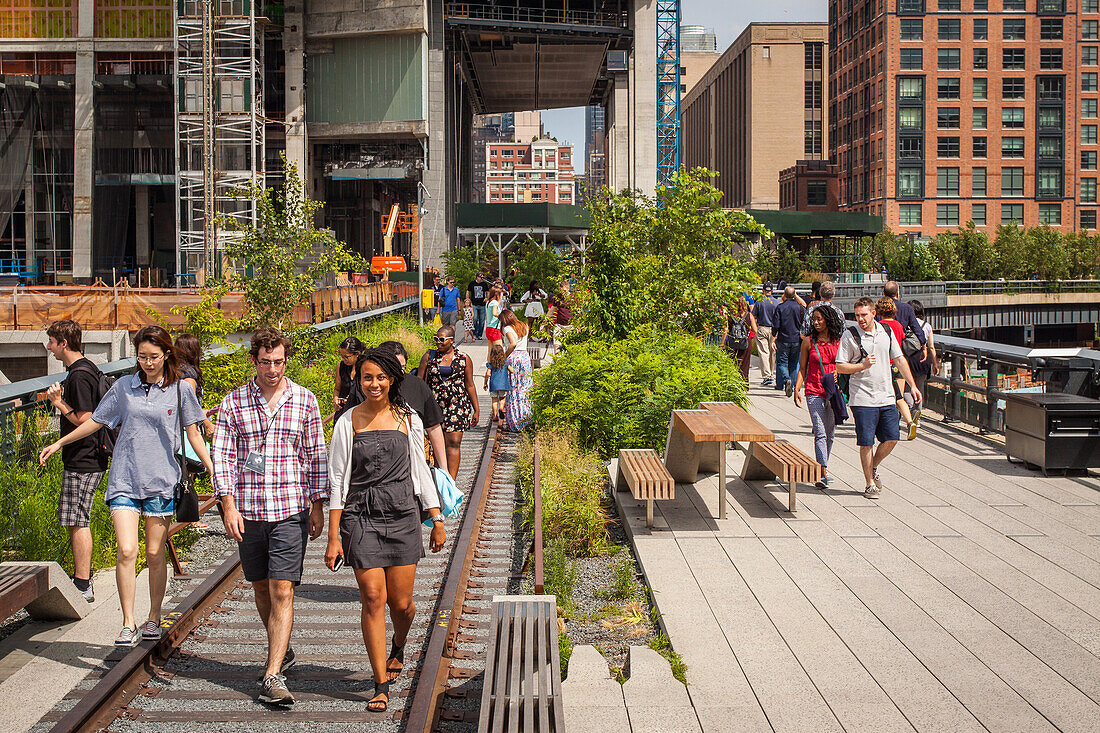 tourists and new yorkers strolling along the plant-filled high line promenade, chelsea, manhattan, new york city, state of new york, united states, usa