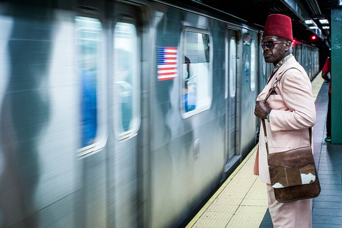 new yorker wearing a fez on a ny subway station platform, fashion, off-beat, manhattan, new york city, state of new york, united states, usa