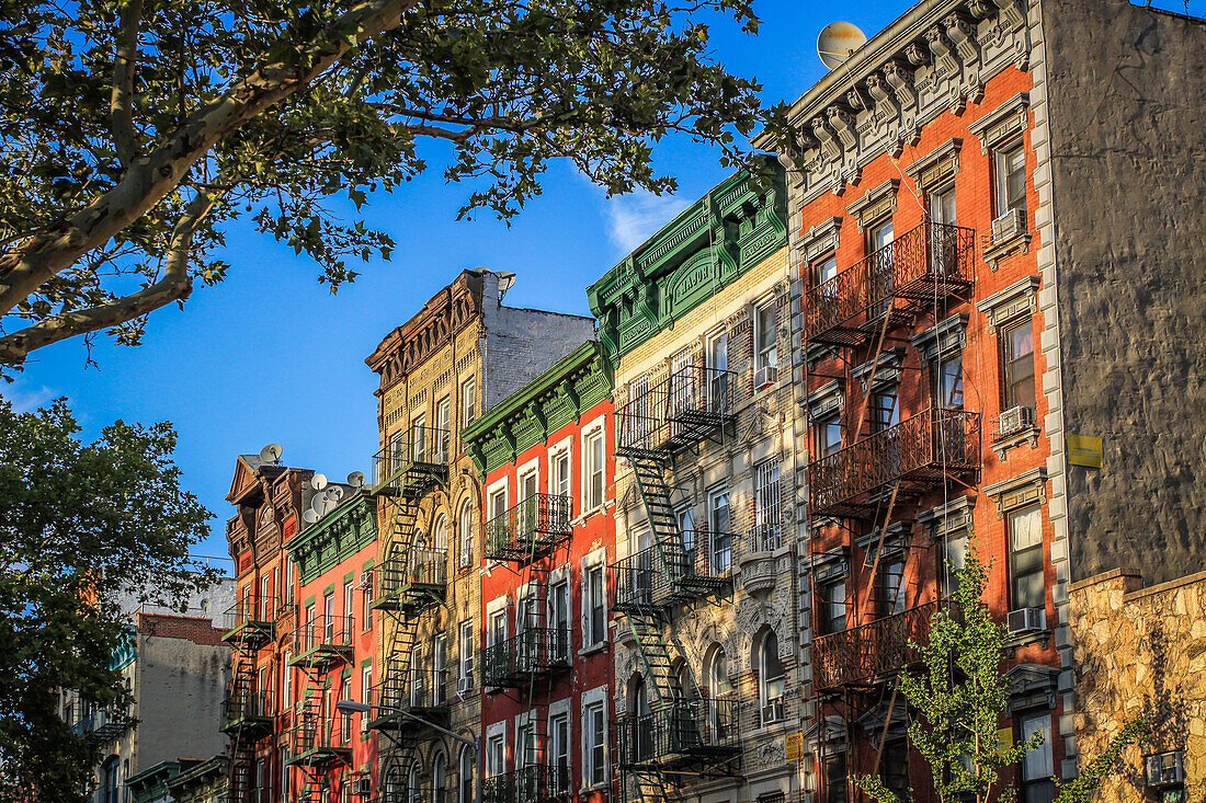 sun setting over the facades of old buildings in the lower east side, manhattan, new york city, state of new york, united states, usa