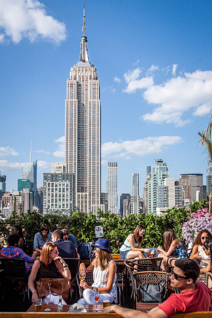 view of the empire state building from the terrace of the 230 fifth rooftop garden bar and restaurant, midtown, manhattan, new york city, state of new york, united states, usa