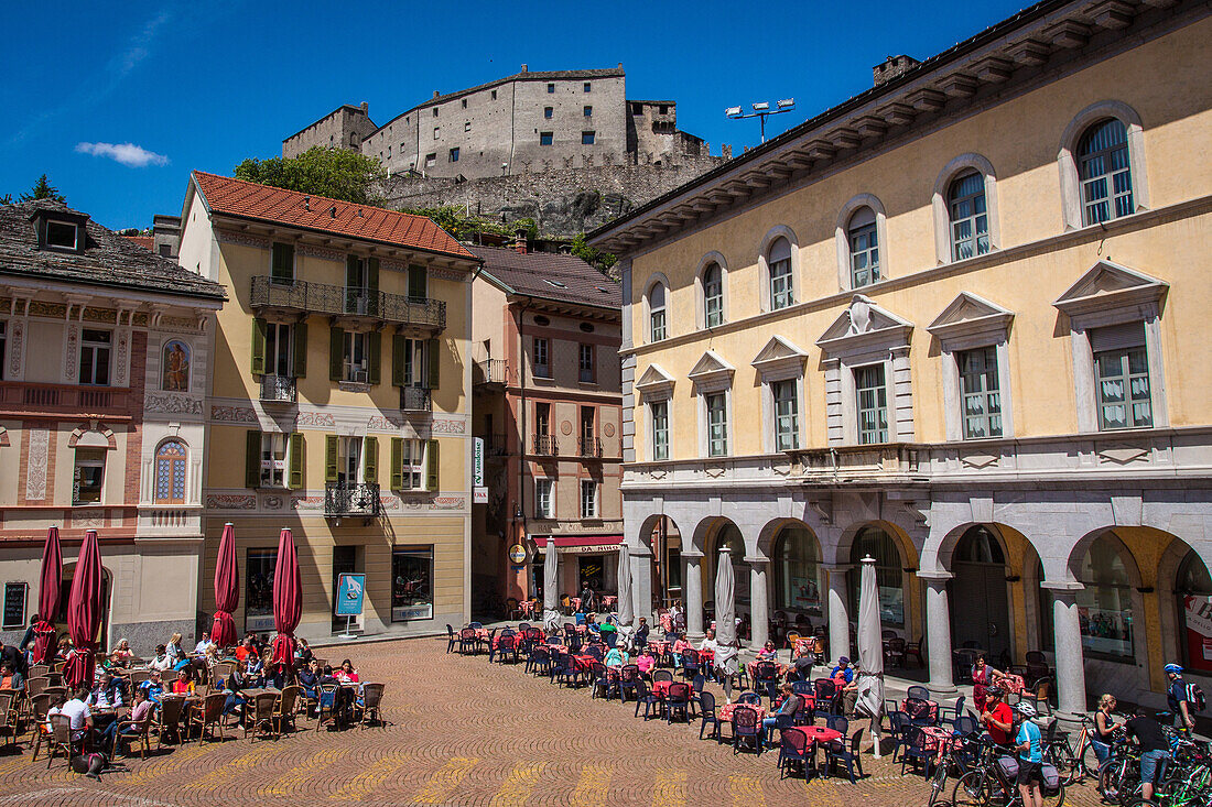 estaurant and cafe terraces on a square in the old town of bellinzona at the foot of castelgrande castle, listed as a world heritage site by unesco, bellinzona, canton of ticino, switzerland