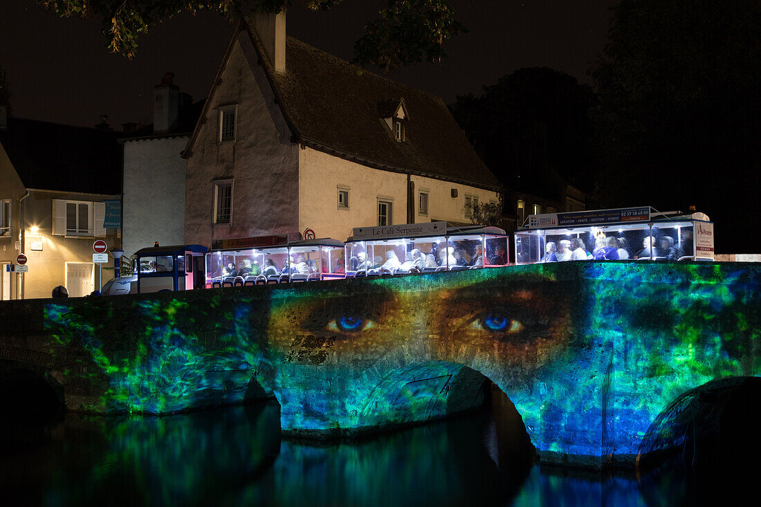 the blue sightseeing train for discovering chartres in lights on the pont des minimes bridge, city of chartres (28), france