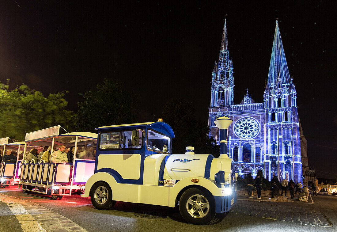 the blue sightseeing train for discovering chartres in lights in front of the cathedral, city of chartres (28), france