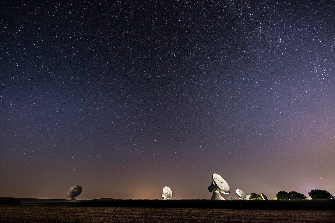 starry sky above the dish aerials of the earth station Raisting, Bavaria, Germany