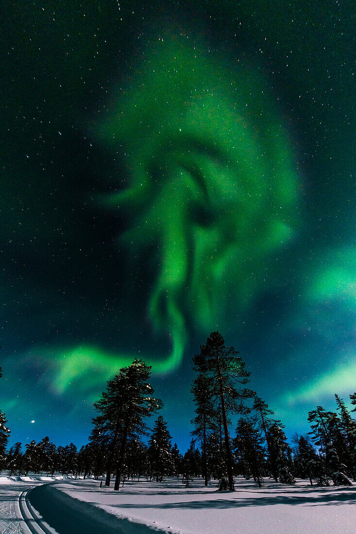 Northern lights above the ski tracks of Luosto, finnish Lapland