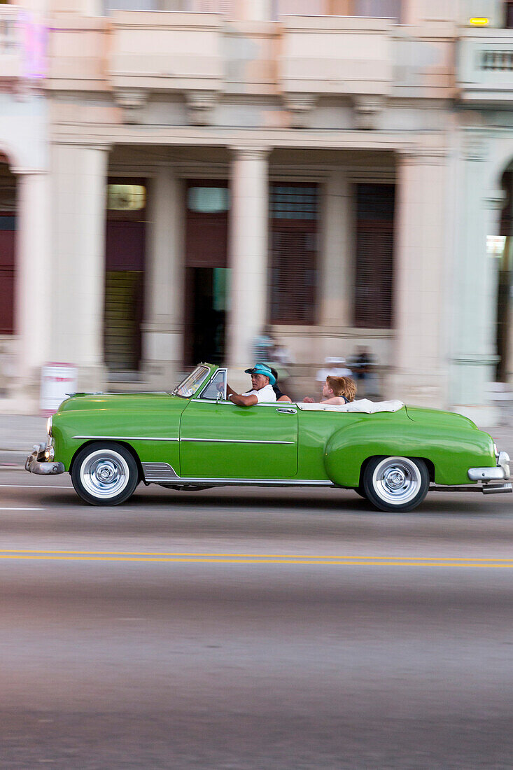 green oldtimer, cabriolet, tourists, driving along Malecon, taxi, historic town, center, old town, Habana Vieja, Habana Centro, family travel to Cuba, holiday, time-out, adventure, Havana, Cuba, Caribbean island