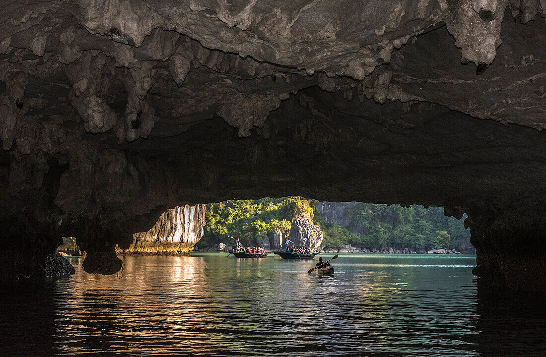 Vietnam, Ha Long Bay, the Tunnel Cave, kayak and small stroll boat (UNESCO World Heritage)