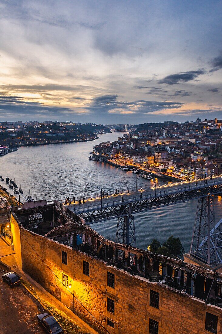 Sunset over Porto city, second largest city in Portugal, Aerial view with Dom Luis I Bridge from Serra do Pilar viewpoint in Vila Nova de Gaia city
