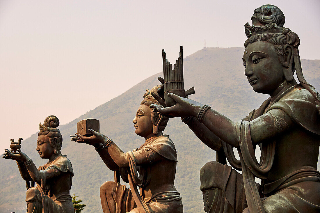Supporting figures make offerings to Big Buddha, Po Lin Monastery, Ngong Ping, Lantau Island, Hong Kong, China, Asia