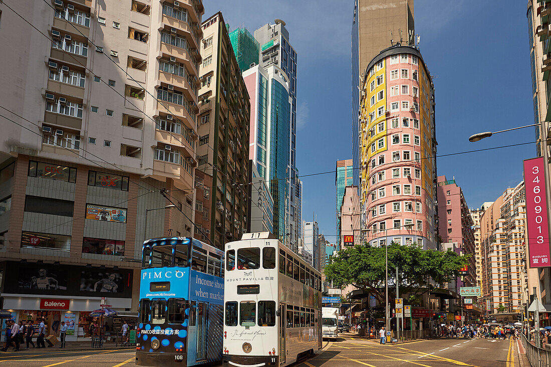 Trams passing through the shopping district, Wan Chai, Hong Kong, China, Asia