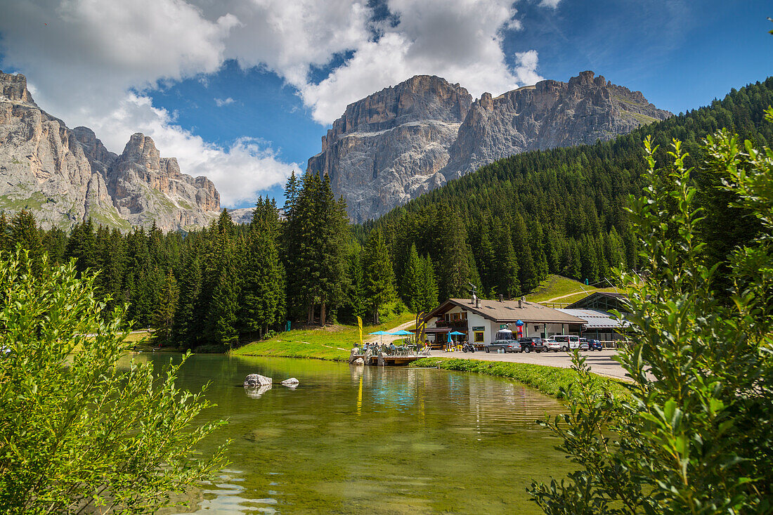 Lake near Hotel Lupo Bianco Wellness and  Walking Canazei, Passo Pordoi with mountain backdrop, South Tyrol, Italian Dolomites, Italy, Europe