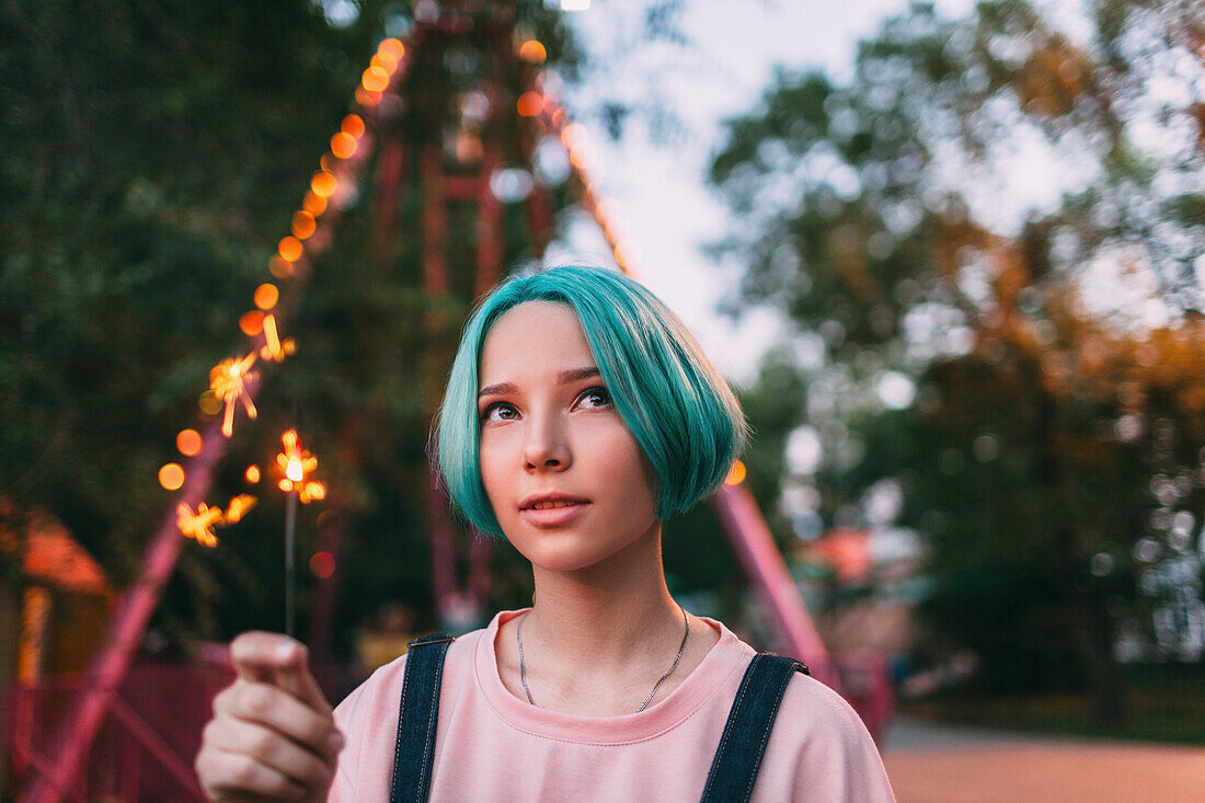 Close-up of teenage girl holding illuminated sparkler