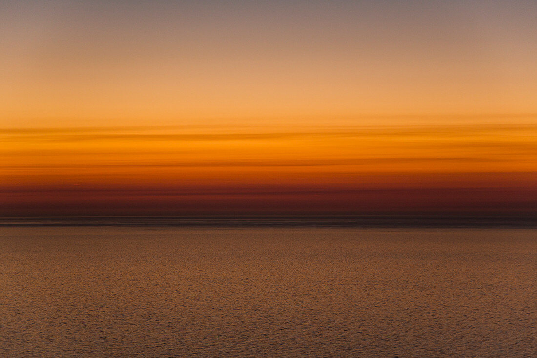 Scenic view of sea against orange sky during sunset