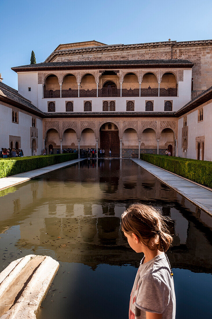 Child in the courtyard of the Alhambra, Granada, Andalusia, Spain, Europe