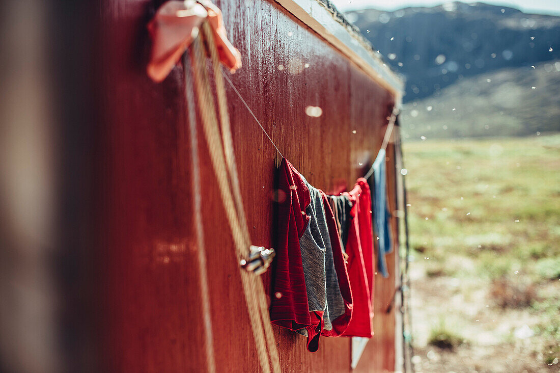 Clothes hanging in front of a red cabin in greenland, greenland, arctic.
