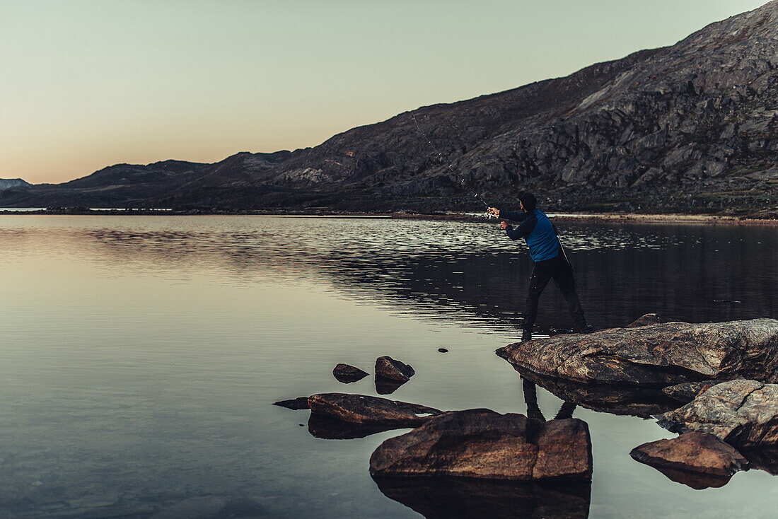 Man fishing in the nature of Greenland, greenland, arctic.