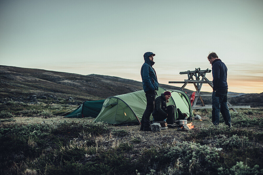 Hiker in front of two tents in greenland, greenland, arctic.