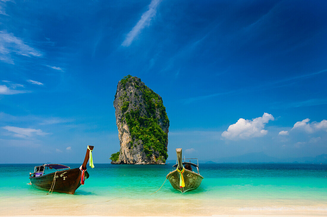 longtailboats and view to the huge rock in front of Koh Poda, Andaman sea, Krabi, Thailand