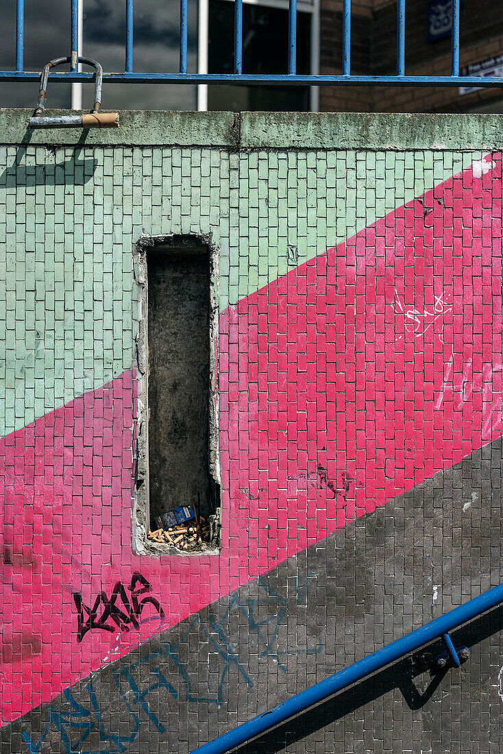 hole in wall of subway is now being used as ashtray, Belfast, Northern Ireland, United Kingdom, Europe