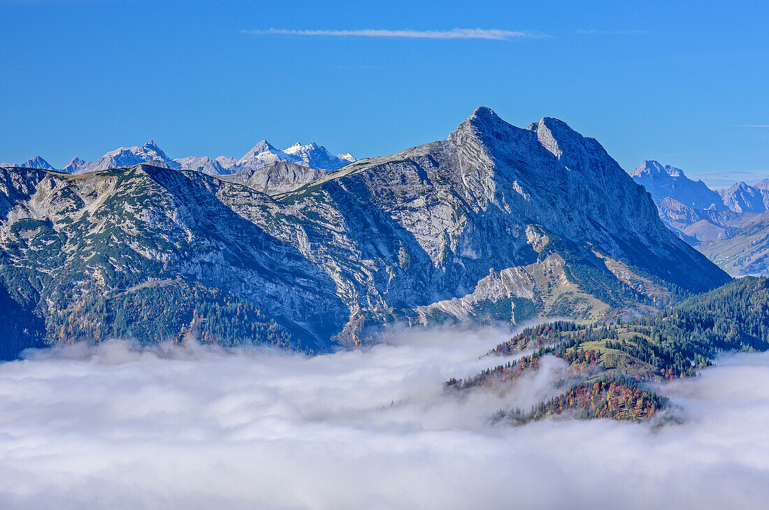 View towards Karwendel range and Guffert, fog in the valley, from Hinteres Sonnwendjoch, Bavarian Alps, Tyrol, Austria