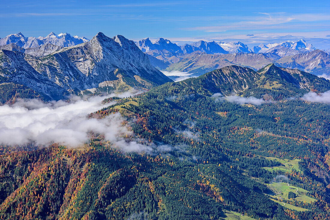 View towards Karwendel, Guffert and Zugspitze, fog in the valley, from Hinteres Sonnwendjoch, Bavarian Alps, Tyrol, Austria