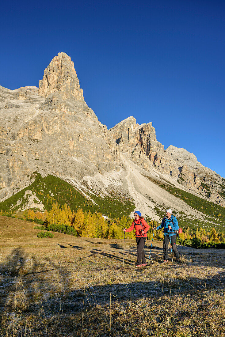 Man and woman hiking beneath Monte Pelmo, Monte Pelmo, Dolomites, UNESCO World Heritage Site Dolomites, Venetia, Italy