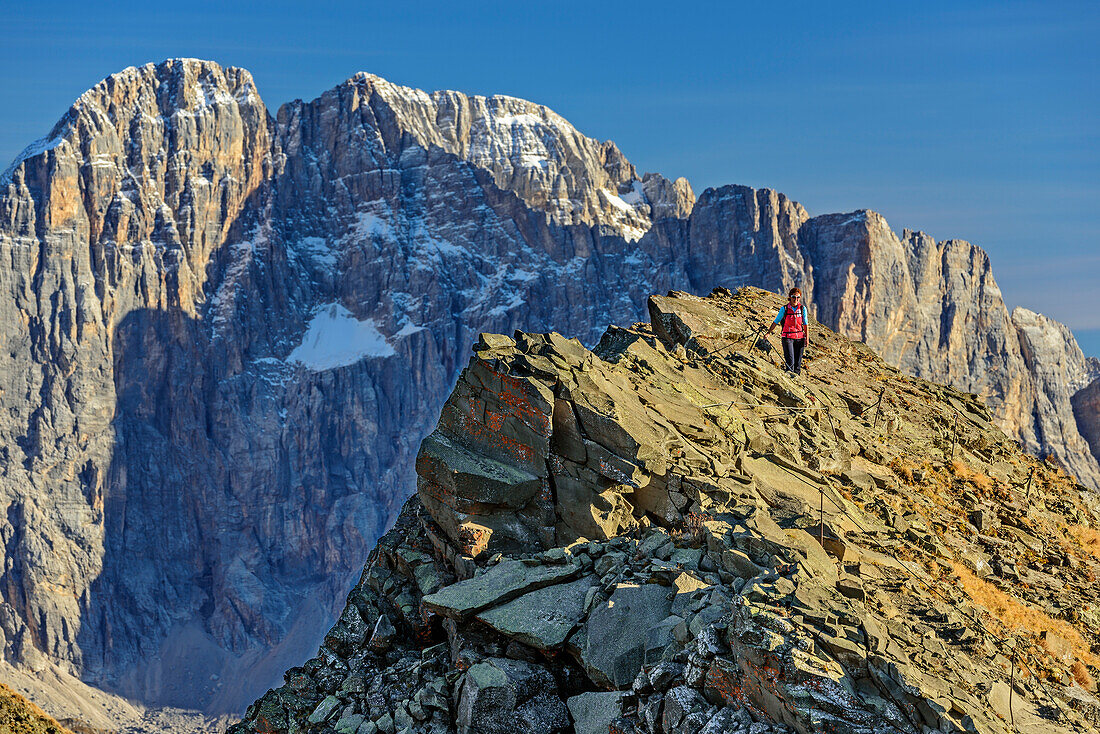 Woman hiking descending from Col di Lana, Civetta in background, Col di Lana, Dolomites, UNESCO World Heritage Site Dolomites, Venetia, Italy