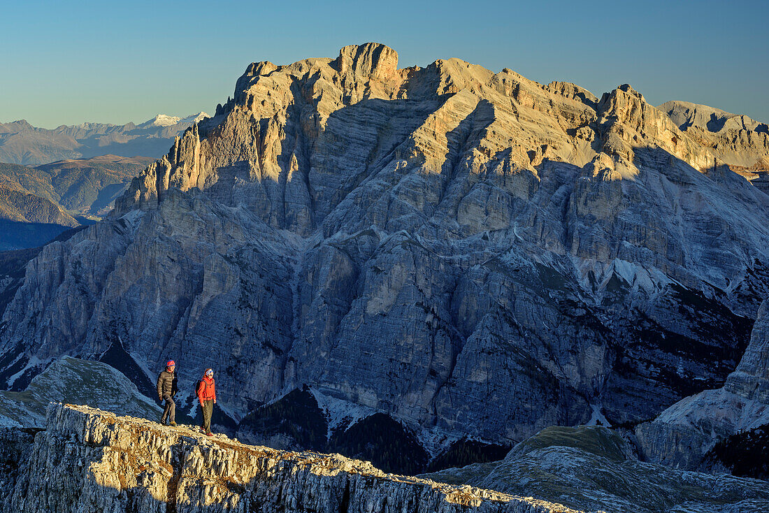 Man and woman hiking, Lavarella in background, from Lagazuoi, Dolomites, UNESCO World Heritage Site Dolomites, Venetia, Italy