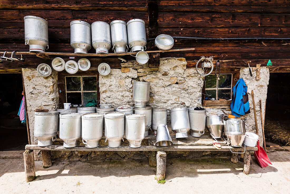 A cowshed with milk cans and tools in the sun, Ginzling, Zillertal, Tyrol, Austria