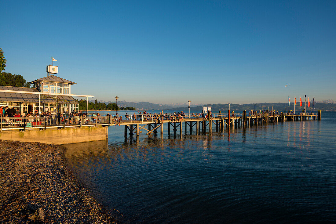 People on jetty at sunset, ship landing stage, Kressbronn, Lake Constance, Baden-Württemberg, Germany