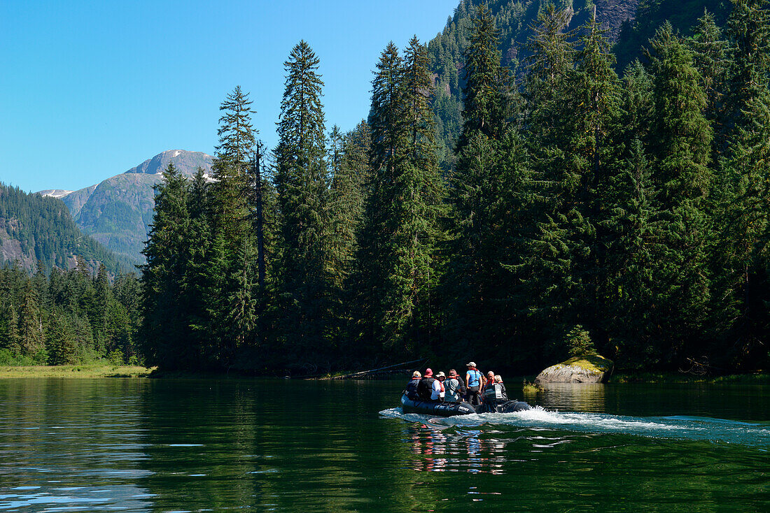 Passengers of expedition cruise ship MS Bremen (Hapag-Lloyd Cruises) in a Zodiac raft explore a side-arm of Rudyerd Bay, Misty Fjords National Monument, Tongass National Forest, southeast Alaska, USA, North America