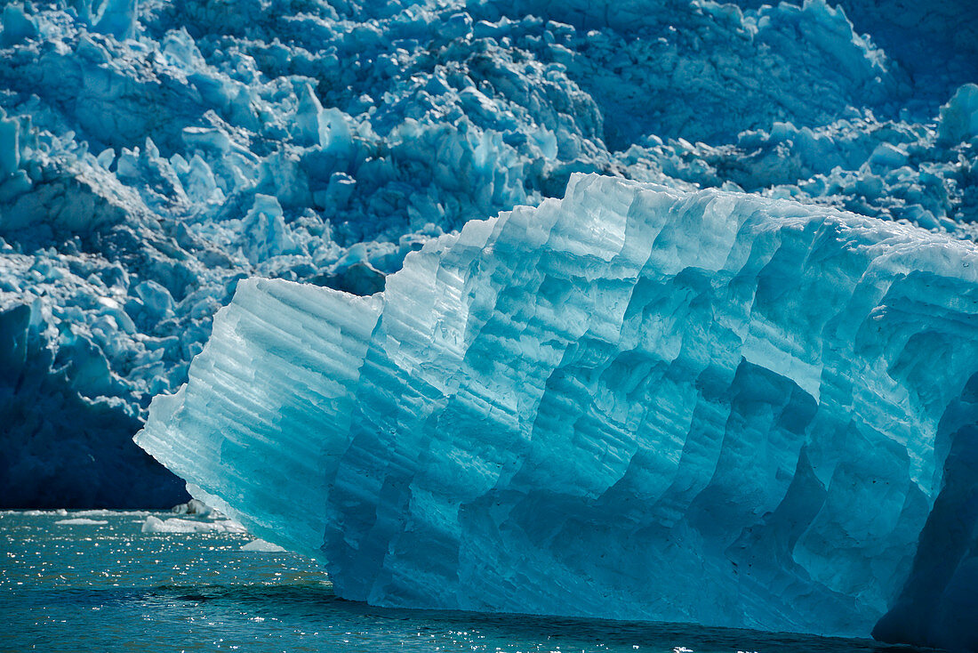 A large iceberg of translucent ice floats in front of the Sawywer Glacier, Tracy Arm, Stephens Passage, Tongass National Forest, Tracy Arm-Fords Terror Wilderness, Alasksa, USA, North America