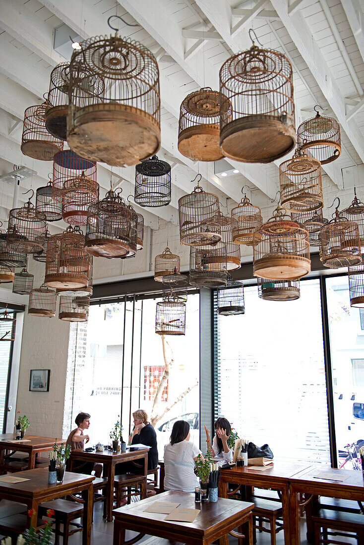 Chinese bird cages decorate the ceiling of the tea house at the White Rabbit Gallery in Chippendale, Sydney, New South Wales, Australia