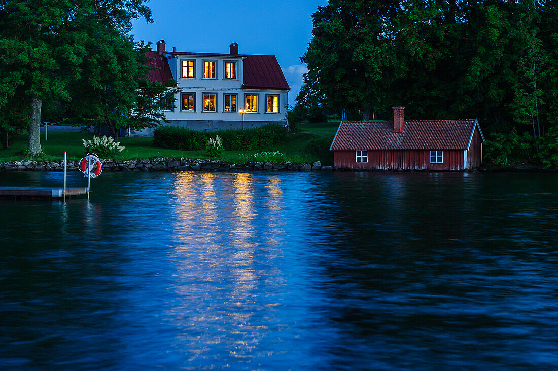 Villa with boathouse at night at Lake Vaettern, Lake Vättern, Östergötland, Sweden