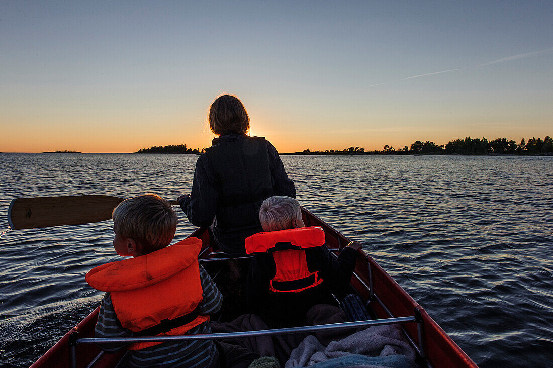 Family paddling, landscape Källandsö at Lake Vänern, Sweden