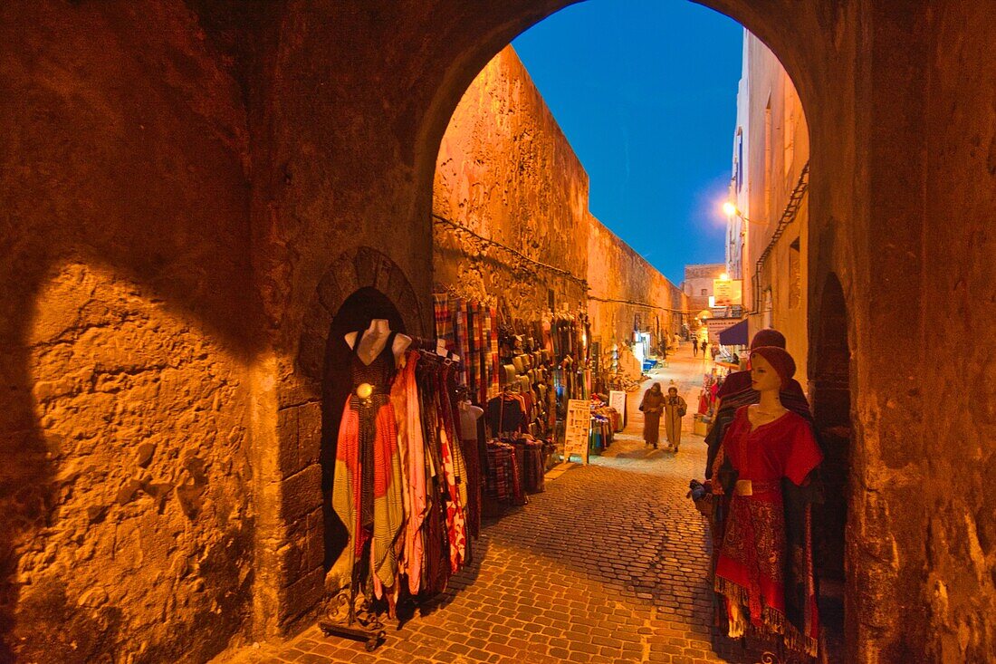 Walls of the old city of Essaouira with souvenir stands in the evening, Morocco