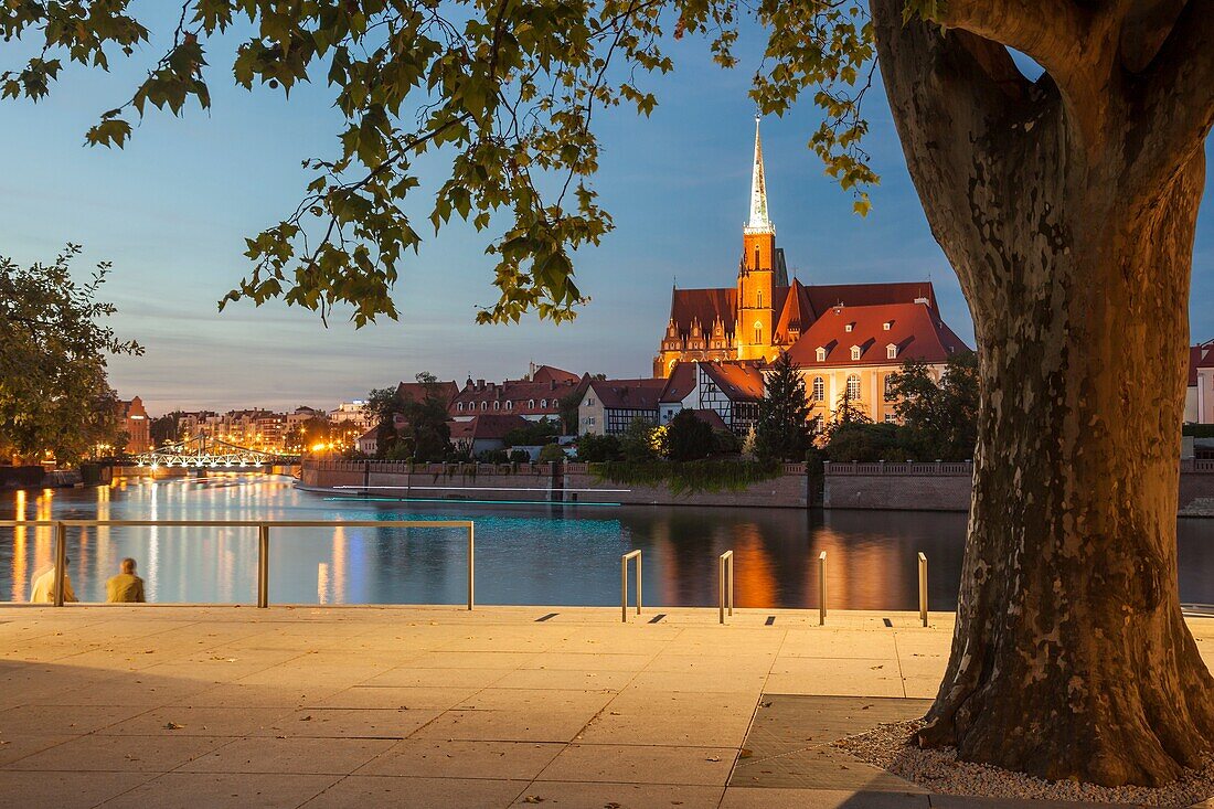 Night falls at Ostrow Tumski in Wroclaw, Poland. Holy Cross church in the distance.