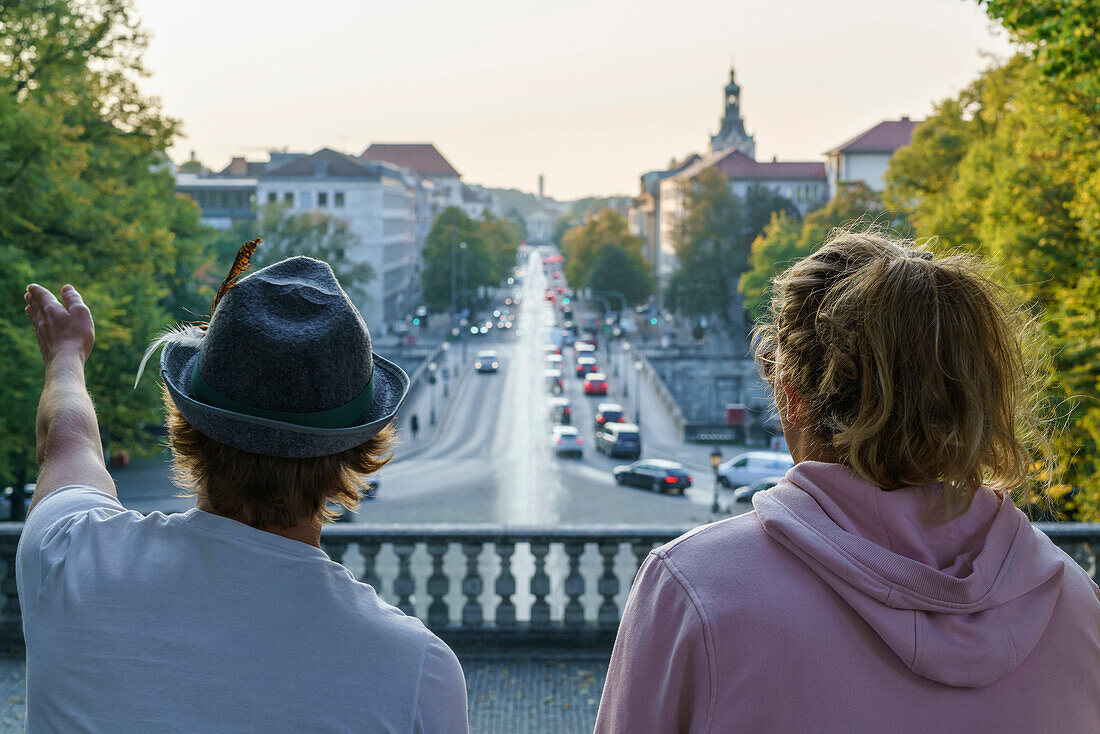 Two young men standing at the Friedensengel, looking over Luitpold Bridge, Munich, Upper Bavaria, Germany