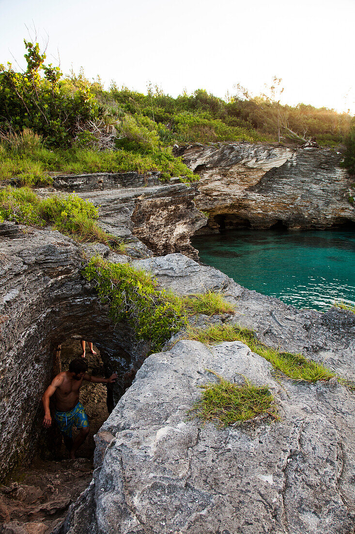 BERMUDA. Hamilton Parish. Cliff jumping, swimming off a point in Admiralty House Park in Hamilton.