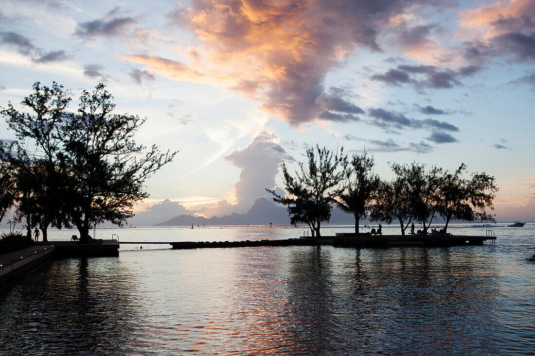 FRENCH POLYNESIA, Tahiti. View of Moorea Island in the distance at sunset as seen from the Manava Suite Resort Tahiti.