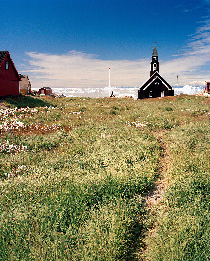 GREENLAND, Ilulissat, Disco Bay, exterior of church with field