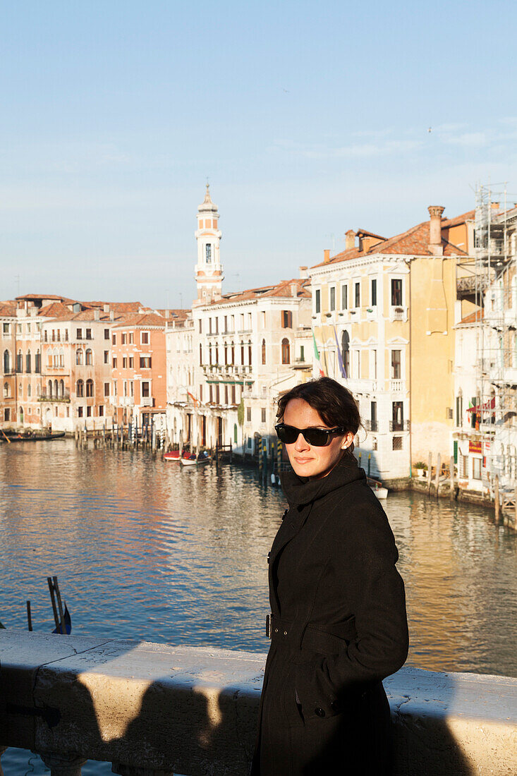 ITALY, Venice. Artist Mia Kaplan on the Rialto Bridge overlooing the Grand Canal.