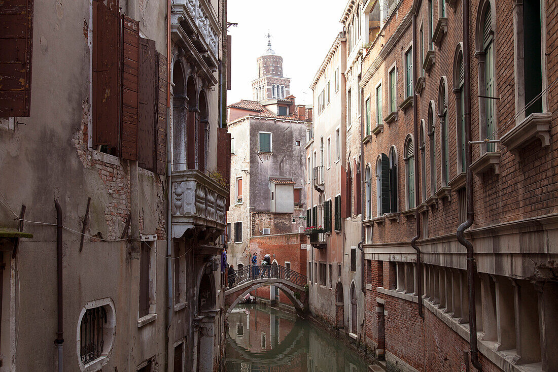 ITALY, Venice.  View of homes and bridge over a canal.