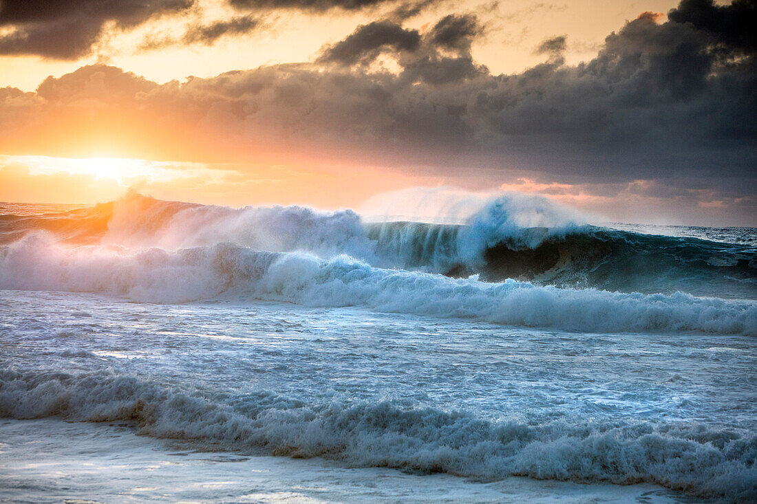 HAWAII, Oahu, North Shore, Big Swell rolling in at sunset at Pupukea Beach Park on the North Shore